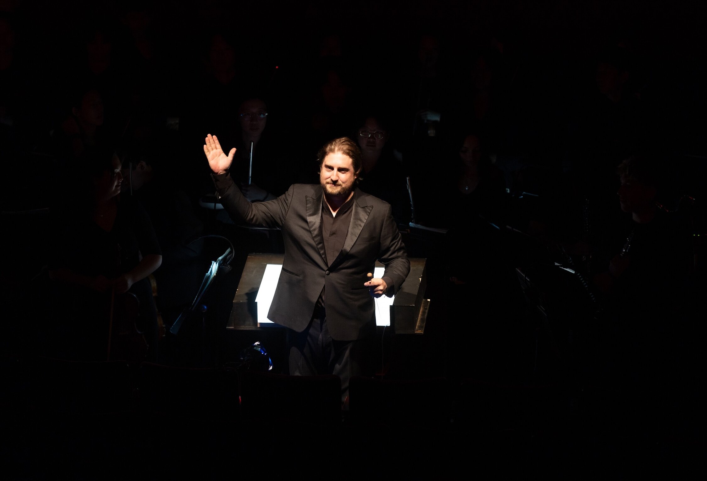 Matthew Kasper waving to an audience.