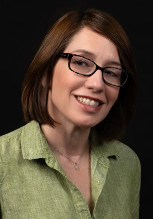 Maria Simonetti - Rehearsal Director, Ballet Arizona, wearing a green shirt with a black background.